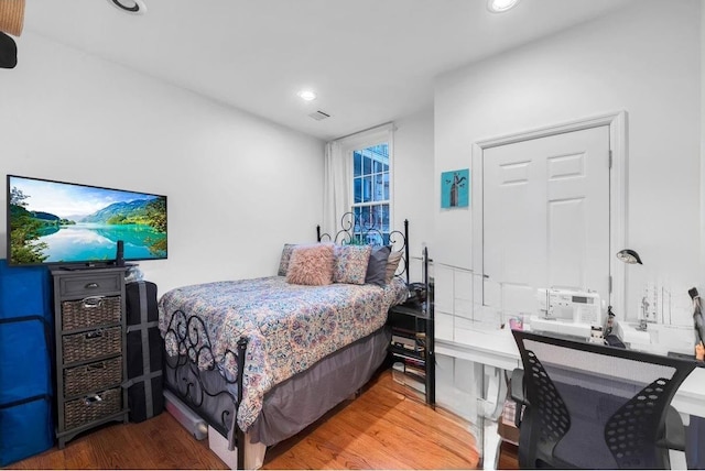 bedroom featuring wood finished floors, visible vents, and recessed lighting