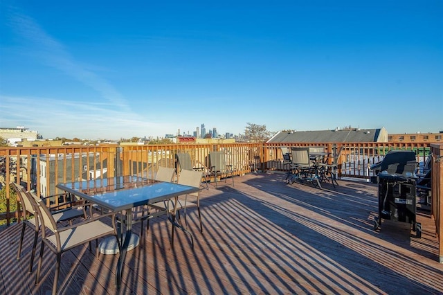 wooden terrace with outdoor dining space