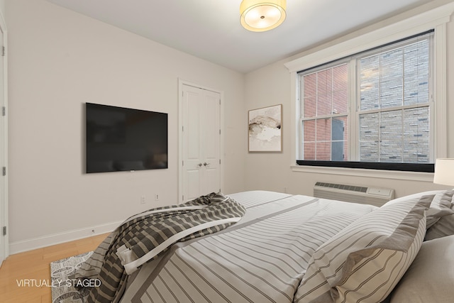104 Tidewater St Unit 1A, Jersey City, NJ 07302 - bedroom with light wood-type flooring and a wall mounted AC