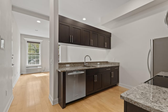 104 Tidewater St Unit 1A, Jersey City, NJ 07302 - kitchen featuring stainless steel appliances, dark brown cabinets, light wood-style flooring, light stone countertops, and recessed lighting