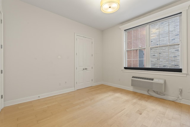 104 Tidewater St Unit 1A, Jersey City, NJ 07302 - unfurnished room featuring a wall mounted air conditioner and light wood-style flooring