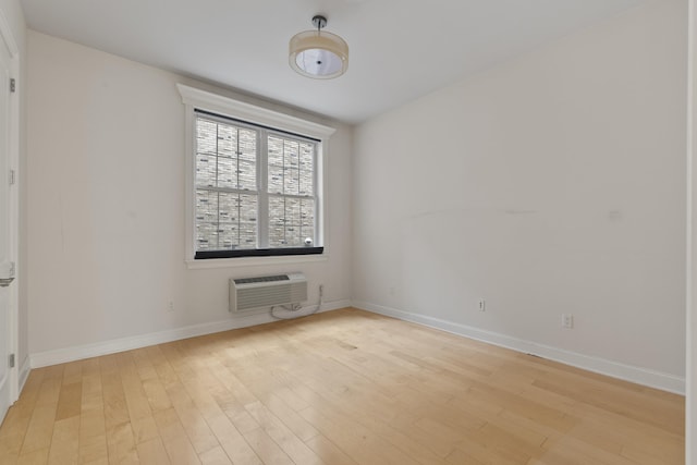 104 Tidewater St Unit 1A, Jersey City, NJ 07302 - spare room with an AC wall unit and light wood-style flooring