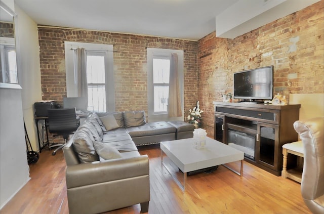37 Harmon St, Jersey City, NJ 07304 - living room featuring hardwood / wood-style flooring and brick wall