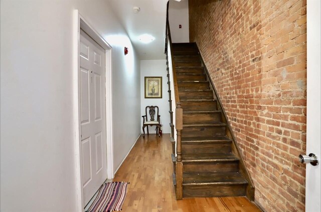 37 Harmon St, Jersey City, NJ 07304 - staircase featuring brick wall and wood finished floors
