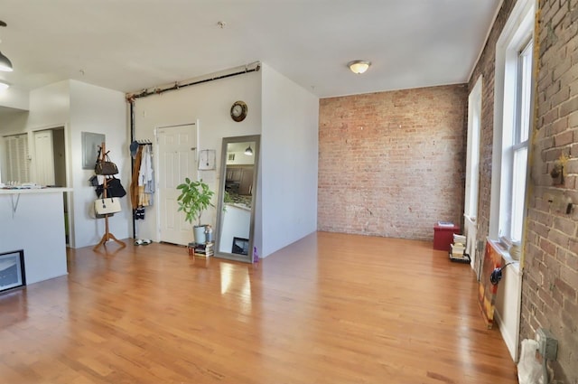 37 Harmon St, Jersey City, NJ 07304 - empty room featuring brick wall and light wood-type flooring
