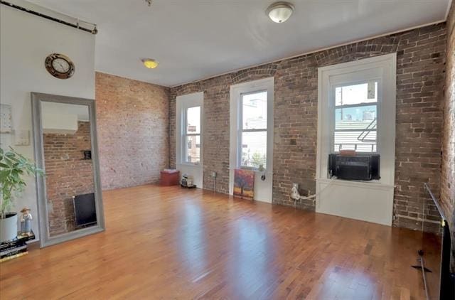 37 Harmon St, Jersey City, NJ 07304 - interior space featuring wood finished floors, cooling unit, and brick wall