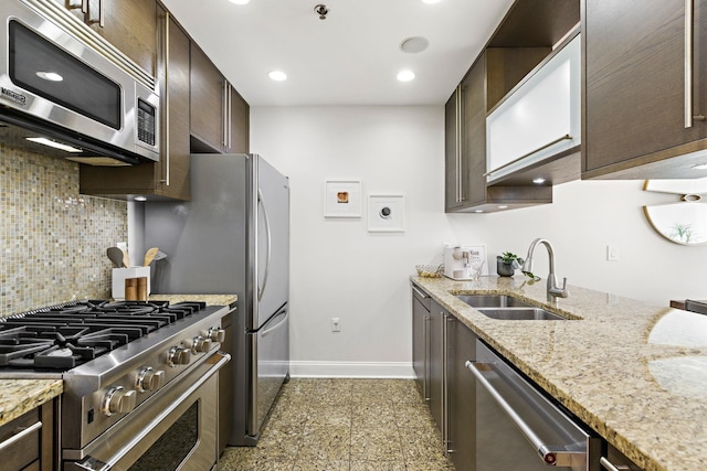 10 Regent St Unit 817, Jersey City, NJ 07302 - kitchen featuring appliances with stainless steel finishes, dark brown cabinets, backsplash, light stone countertops, and recessed lighting