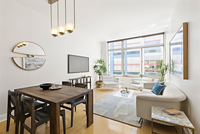 10 Regent St Unit 817, Jersey City, NJ 07302 - dining room with light wood-style flooring and a chandelier