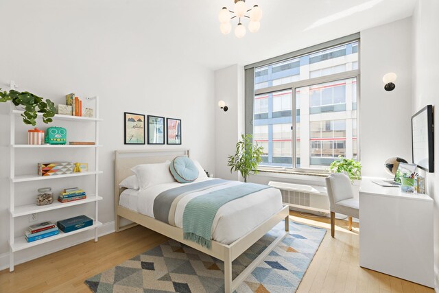 10 Regent St Unit 817, Jersey City, NJ 07302 - bedroom featuring light wood finished floors and a chandelier