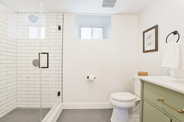 bathroom with a stall shower, visible vents, vanity, and toilet