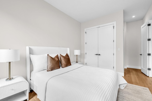 2602 Palisade Ave, Weehawken, NJ 07086 - bedroom featuring light wood-type flooring, a closet, recessed lighting, and baseboards