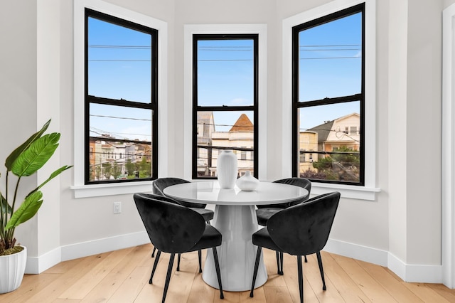 2602 Palisade Ave, Weehawken, NJ 07086 - dining space featuring baseboards, plenty of natural light, and hardwood / wood-style flooring