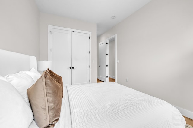 2602 Palisade Ave, Weehawken, NJ 07086 - bedroom featuring a closet, baseboards, and wood finished floors