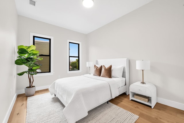 2602 Palisade Ave, Weehawken, NJ 07086 - bedroom with light wood-style flooring, baseboards, and vaulted ceiling