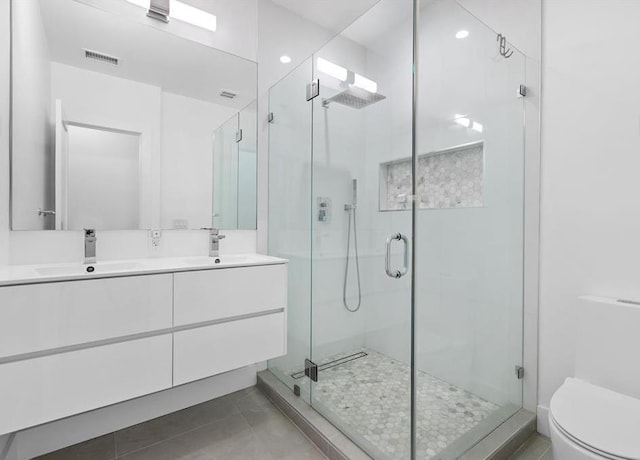 2602 Palisade Ave, Weehawken, NJ 07086 - full bath featuring toilet, a shower stall, double vanity, and tile patterned floors