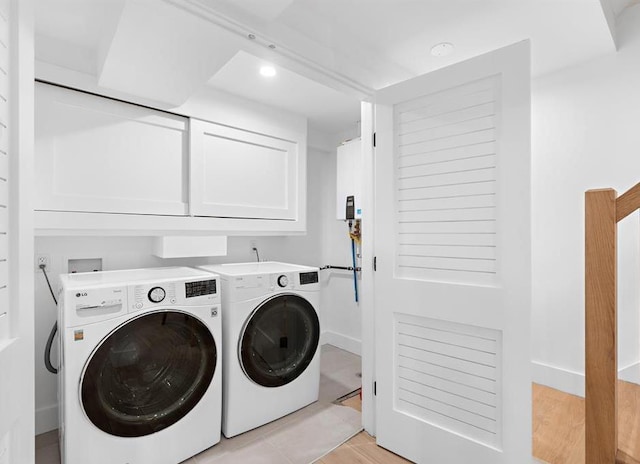2602 Palisade Ave, Weehawken, NJ 07086 - laundry area featuring washing machine and dryer, cabinet space, light wood finished floors, and recessed lighting