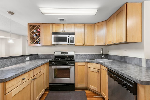 700 1st St Unit 6D, Hoboken, NJ 07030 - kitchen featuring appliances with stainless steel finishes, dark wood-style floors, dark countertops, and light brown cabinets