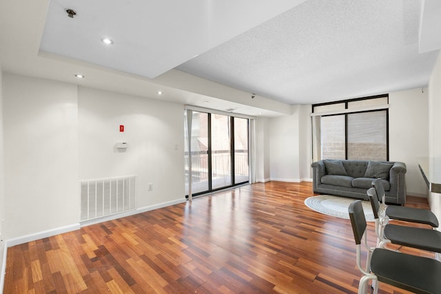 700 1st St Unit 6D, Hoboken, NJ 07030 - living area with wood finished floors, a wall of windows, recessed lighting, and a textured ceiling