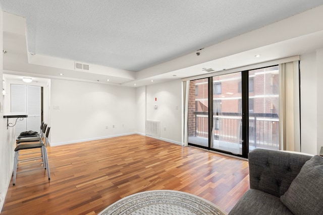 700 1st St Unit 6D, Hoboken, NJ 07030 - unfurnished living room featuring light wood finished floors and a textured ceiling
