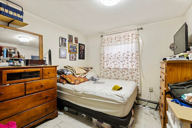 bedroom with marble finish floor and a baseboard radiator