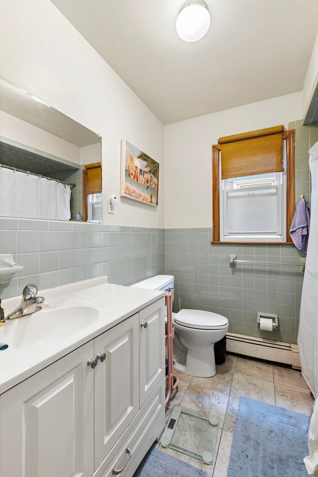 bathroom with a baseboard radiator, toilet, tile walls, and vanity