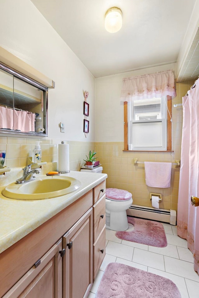 bathroom with vanity, tile patterned flooring, a baseboard heating unit, tile walls, and toilet