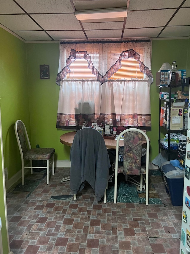 dining room featuring a drop ceiling