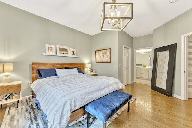 1200 Grand St Unit 220, Hoboken, NJ 07030 - bedroom with light wood-style flooring, a chandelier, and connected bathroom