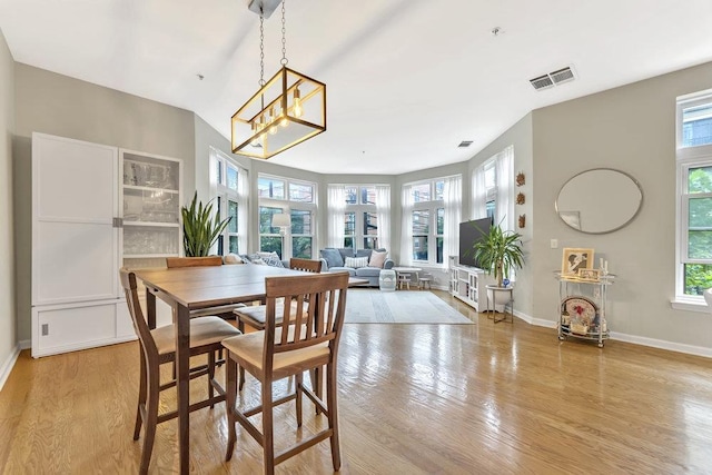1200 Grand St Unit 220, Hoboken, NJ 07030 - dining space with light wood-type flooring, plenty of natural light, and a chandelier