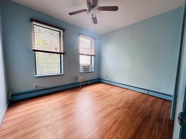 unfurnished room with light wood-type flooring, a wealth of natural light, cooling unit, and ceiling fan