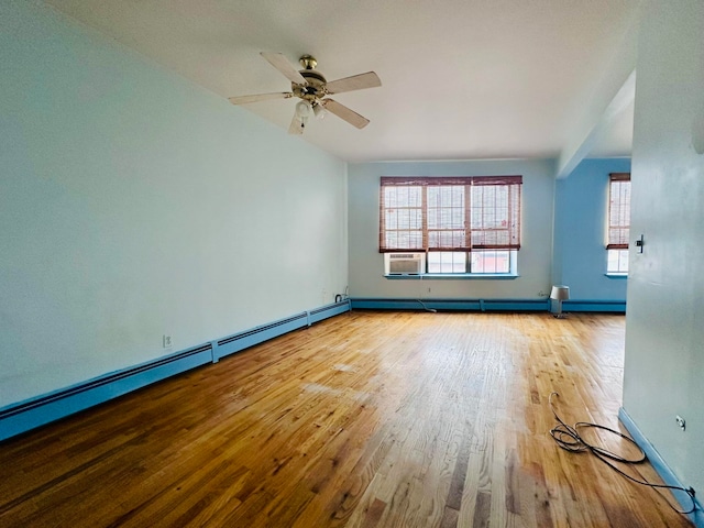 spare room featuring hardwood / wood-style flooring, ceiling fan, and a baseboard radiator