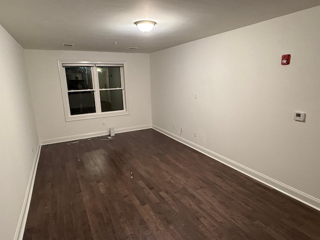 unfurnished room featuring dark hardwood / wood-style floors