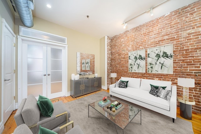 930 Park Ave Unit 3, Hoboken, NJ 07030 - living room featuring french doors, wood finished floors, and brick wall