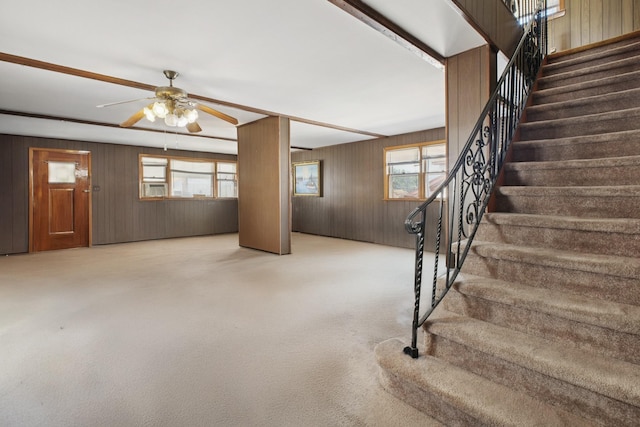 1508 77th St, North Bergen, NJ 07047 - staircase with wood walls, a ceiling fan, and carpet floors