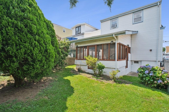 1508 77th St, North Bergen, NJ 07047 - back of house with a sunroom and a lawn