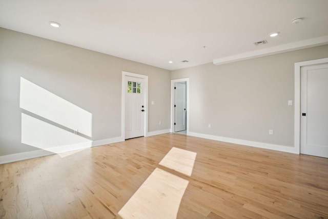 unfurnished room with hardwood / wood-style flooring