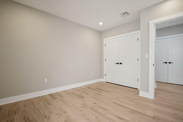 unfurnished bedroom with light wood-type flooring