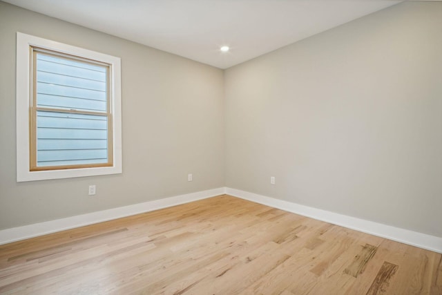 unfurnished room featuring light hardwood / wood-style floors and plenty of natural light