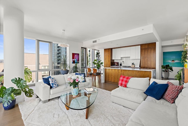 75 Park Ln S Unit 706, Jersey City, NJ 07310 - living area with a notable chandelier, wood finished floors, and visible vents