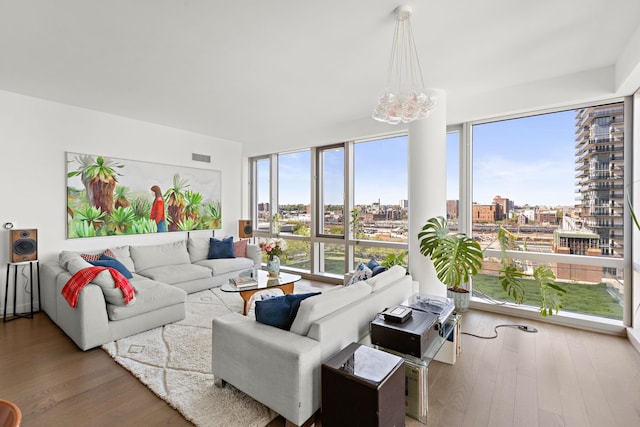 75 Park Ln S Unit 706, Jersey City, NJ 07310 - living room featuring a view of city, a chandelier, a wealth of natural light, and wood finished floors