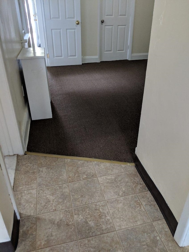 hall with light tile patterned flooring