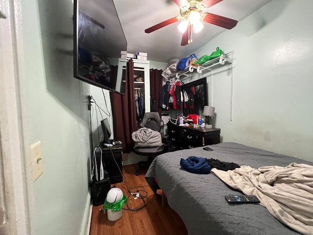 bedroom featuring hardwood / wood-style floors and ceiling fan