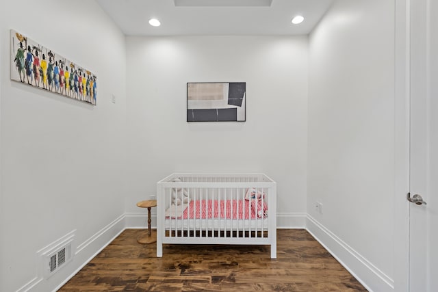 297 Montgomery St Unit 2, Jersey City, NJ 07302 - bedroom with wood finished floors, a nursery area, and recessed lighting