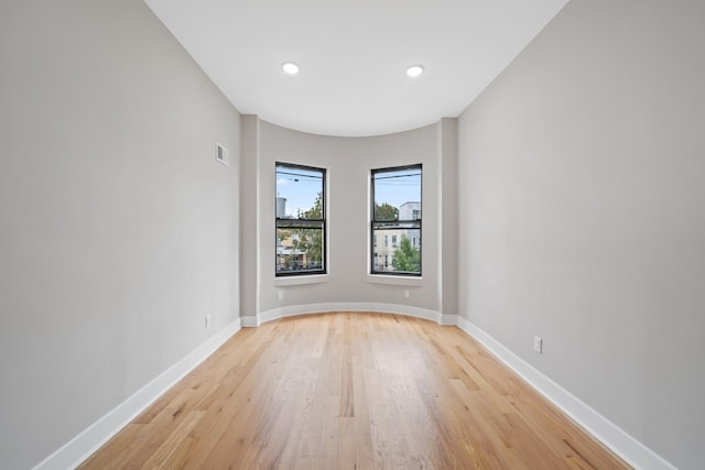 empty room with light hardwood / wood-style flooring