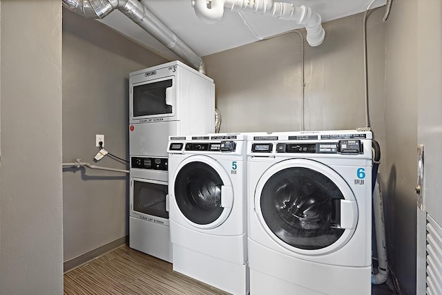 laundry room featuring light wood-type flooring and separate washer and dryer