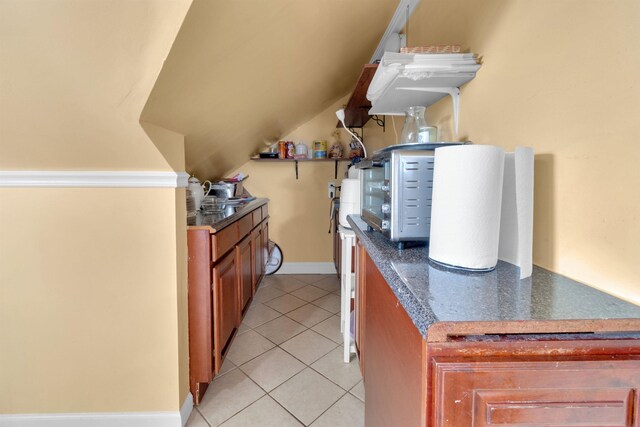 280 Highland Ave Unit 3, Kearny, NJ 07032 - kitchen with dark countertops, brown cabinetry, and light tile patterned floors