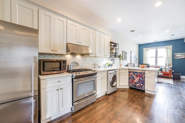 351 5th St Unit 3, Jersey City, NJ 07302 - kitchen featuring stainless steel appliances, under cabinet range hood, washer / dryer, a peninsula, and dark wood-type flooring