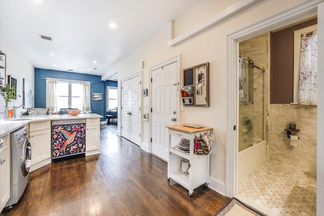 351 5th St Unit 3, Jersey City, NJ 07302 - kitchen featuring washer / clothes dryer, a sink, dark wood-type flooring, white cabinets, and recessed lighting