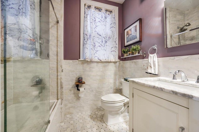 351 5th St Unit 3, Jersey City, NJ 07302 - bathroom featuring tile walls, toilet, vanity, and bath / shower combo with glass door