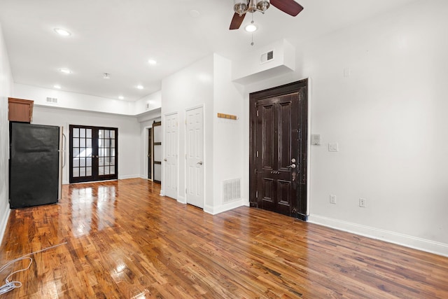 interior space featuring hardwood / wood-style floors, french doors, and ceiling fan